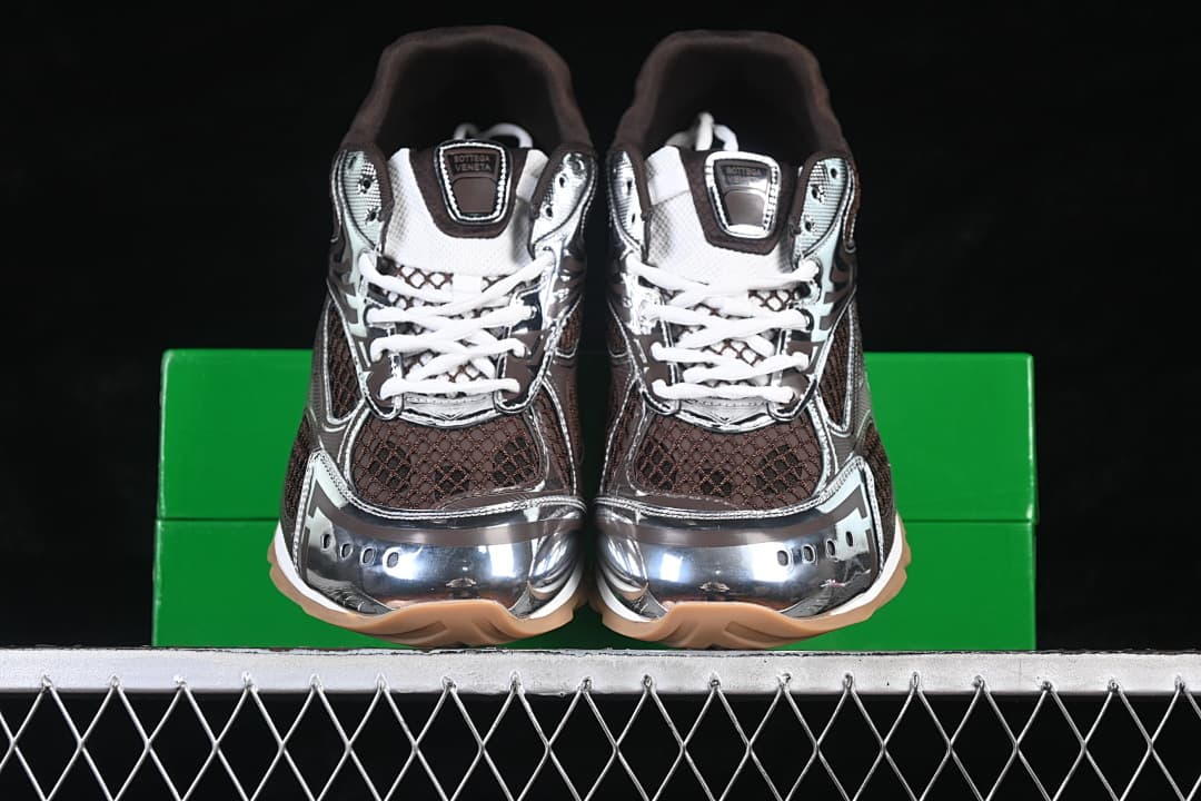 Front view of the pair showing brown mesh-patterned panels, silver-tone toe details and tan outsoles.