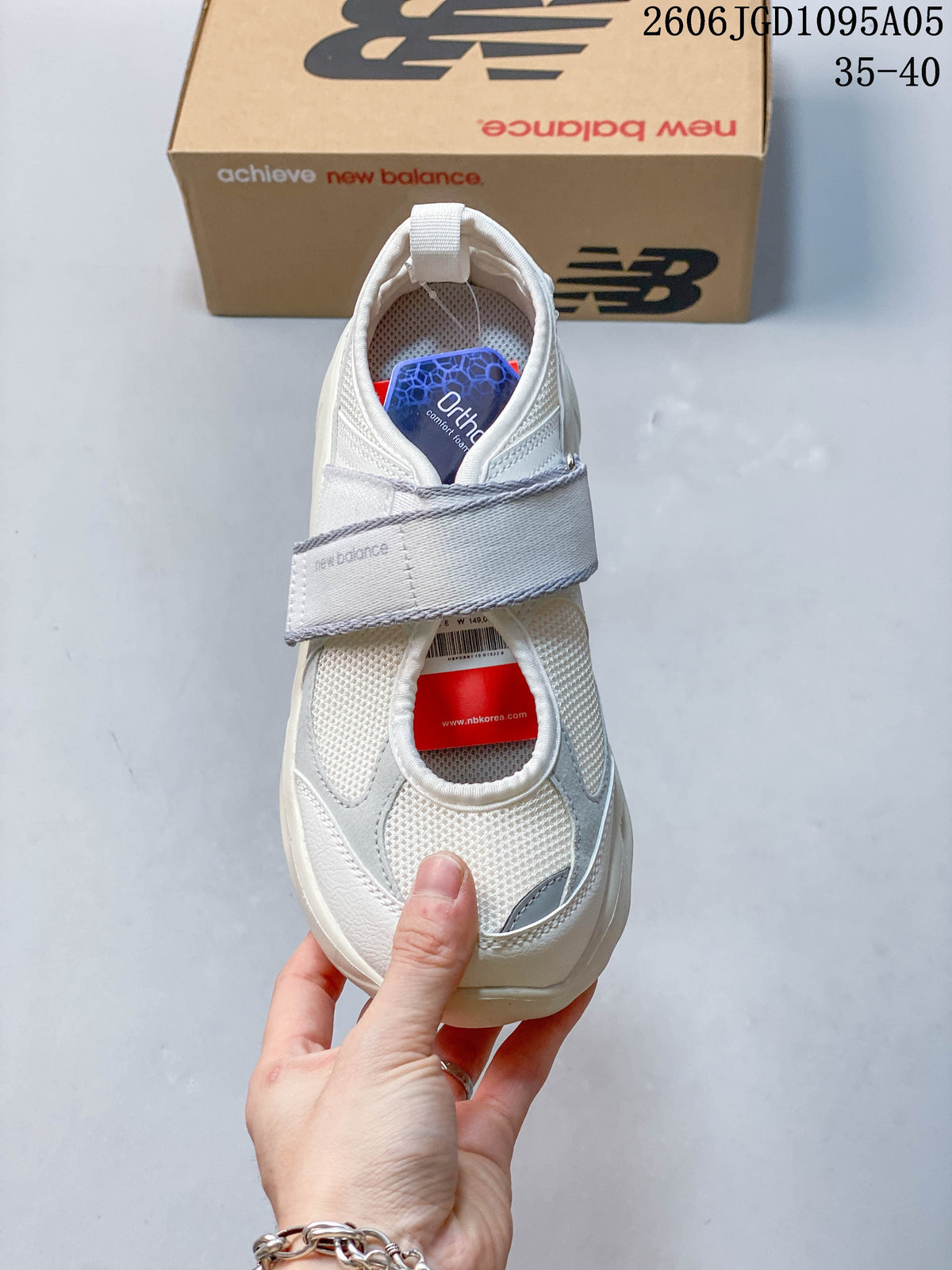 Top view of a white New Balance Breeze sneaker with a broad strap and mesh panels