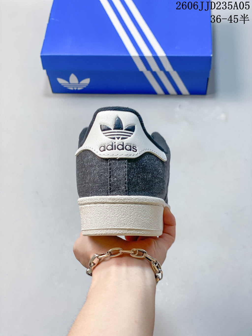 Rear view showing the white heel tab and outsole on a charcoal gray sneaker