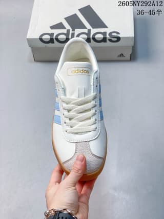 Front view showing white laces, light blue side stripes, and a gum-colored toe outsole.