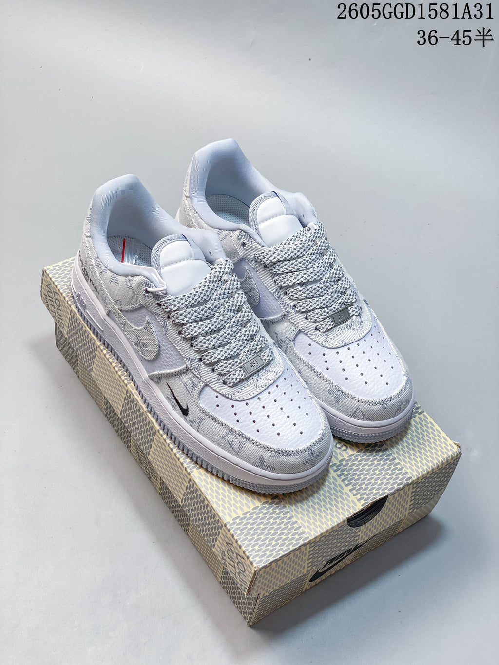 Pair of white and grey patterned Nike Air Force 1 ’07 LV8 low-top sneakers on a patterned box