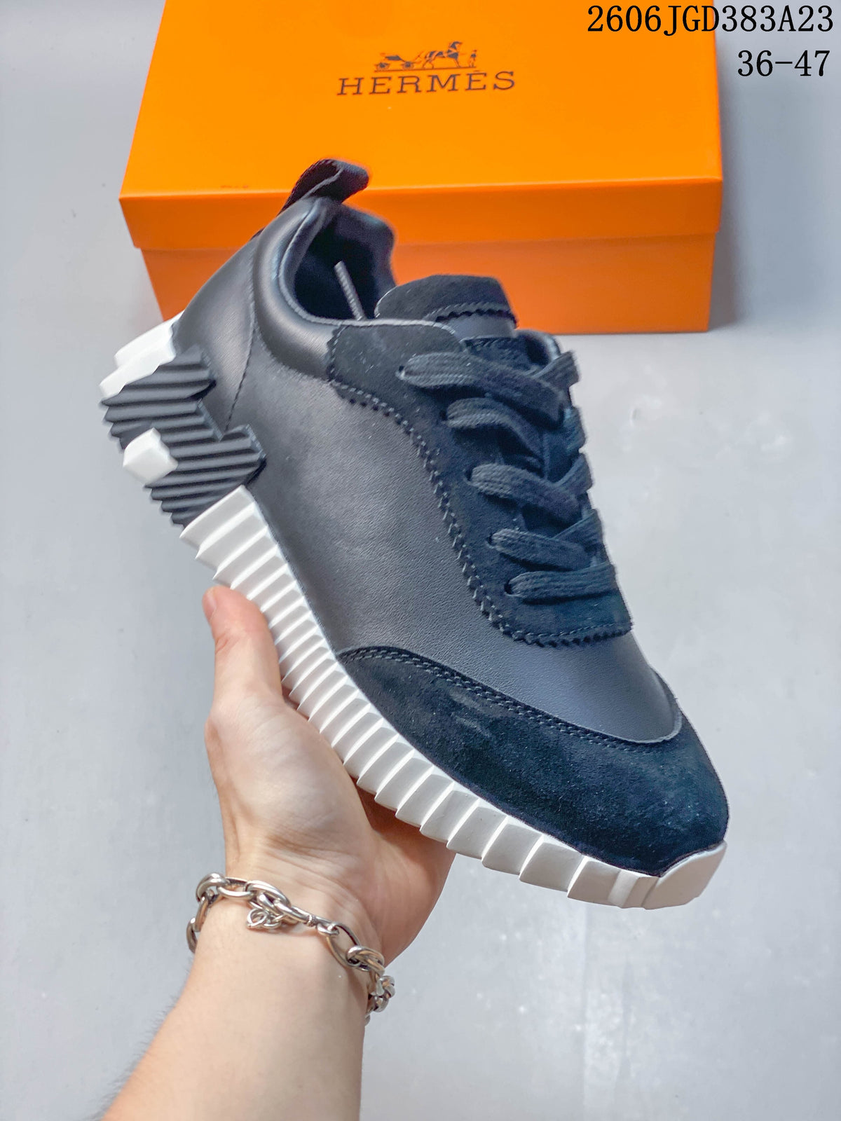 Side view of a dark navy low-top sneaker with a ribbed sole and contrasting heel detail.