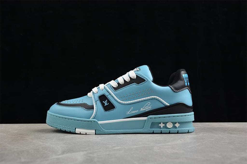Side view of a blue and navy LV Trainer sneaker with white laces and stud details