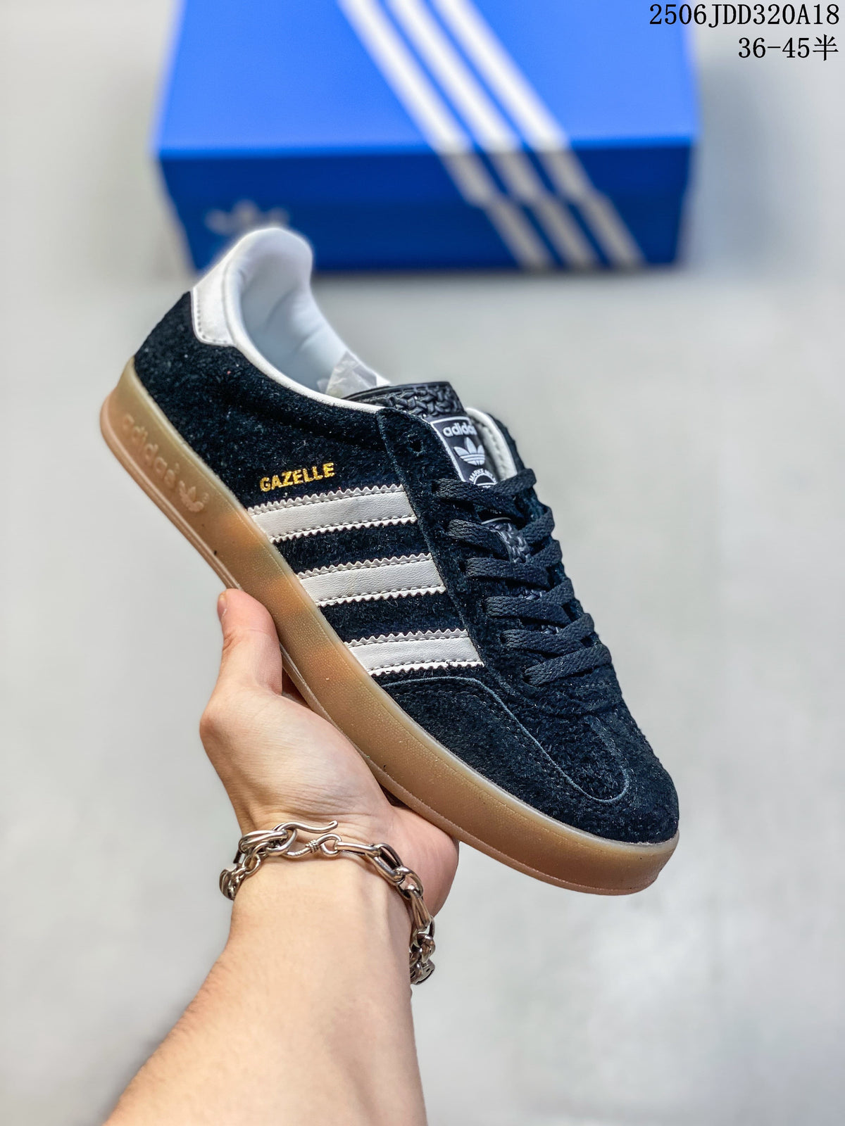 Black Adidas Gazelle low-top sneaker with white stripes and a gum-look sole