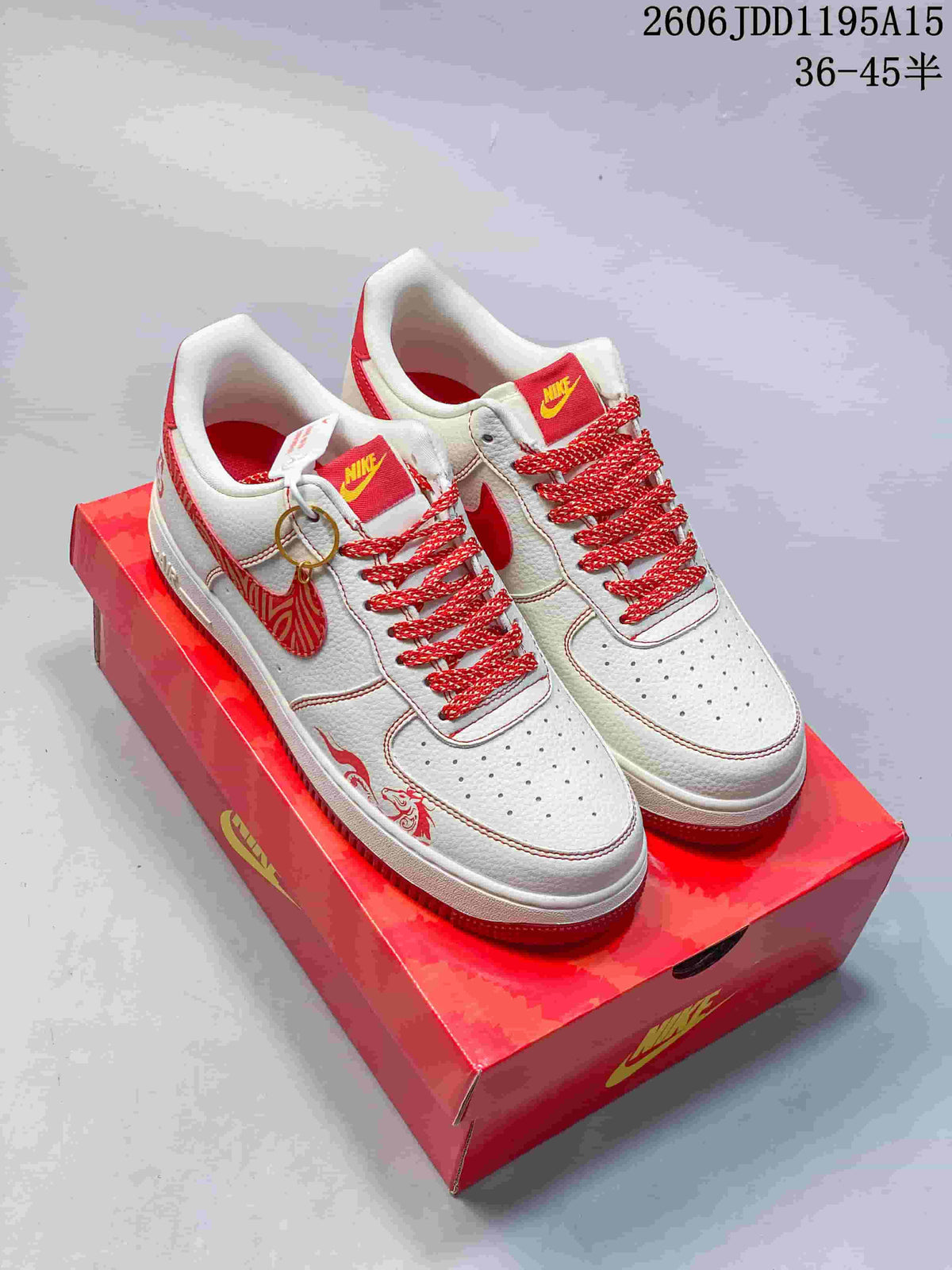 Pair of white and red Nike Air Force 1 Low sneakers with horse-inspired graphics and red presentation box