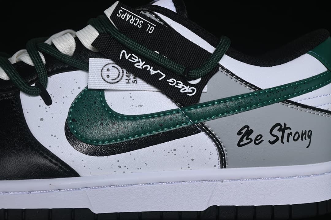 Close-up of green side overlay, strap, and Be Strong lettering