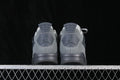 Rear view of grey Air Jordan 4 Retro SE sneakers showing heel panels and pull tabs.
