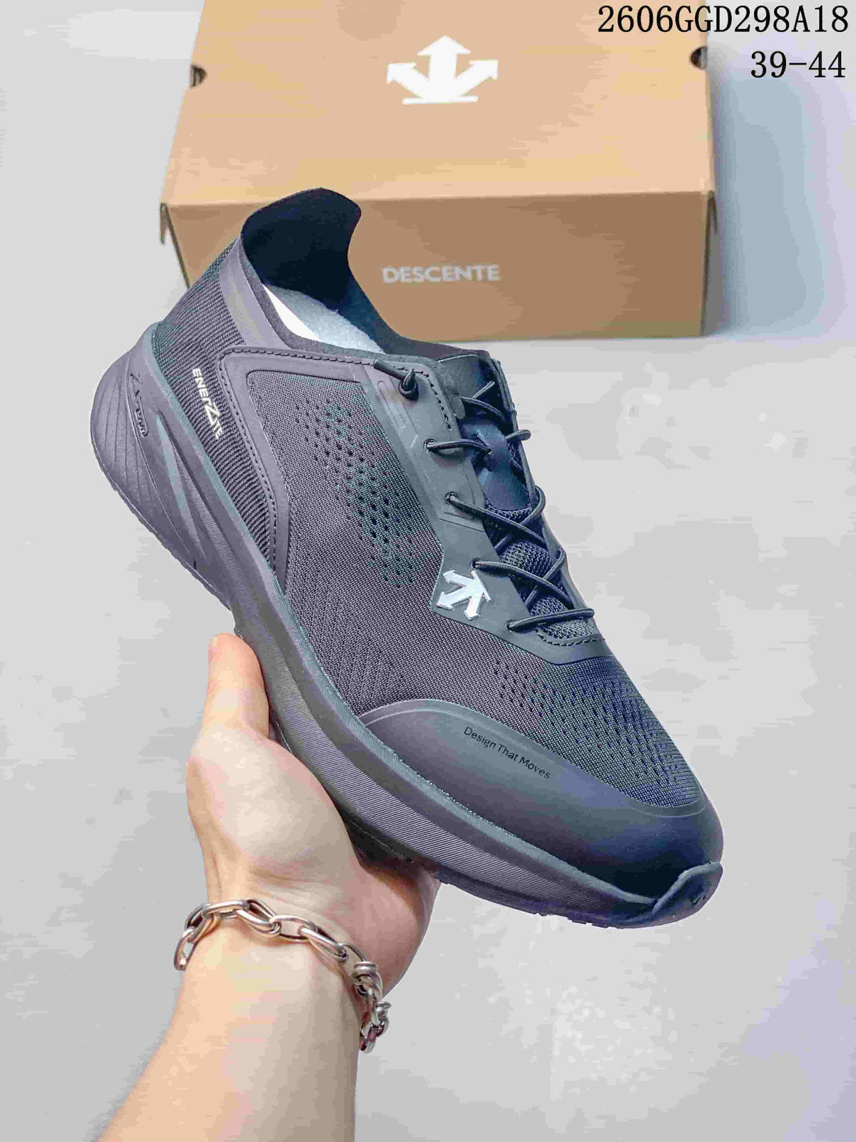 Close-up of a dark navy DESCENTE sneaker showing perforated panels and lace-up closure