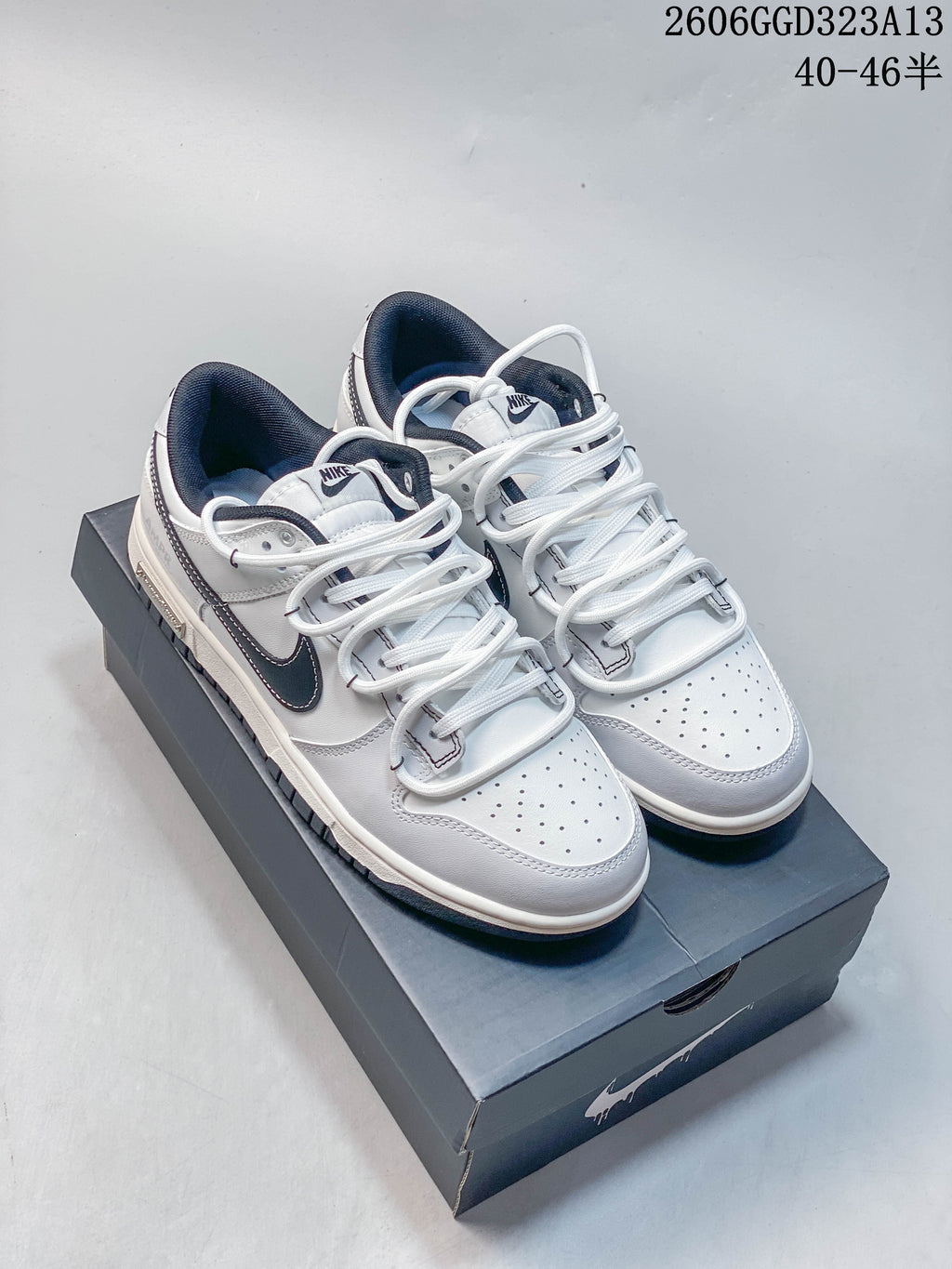 Pair of white and navy Nike SB Dunk Low Pro sneakers, shown from above at an angle