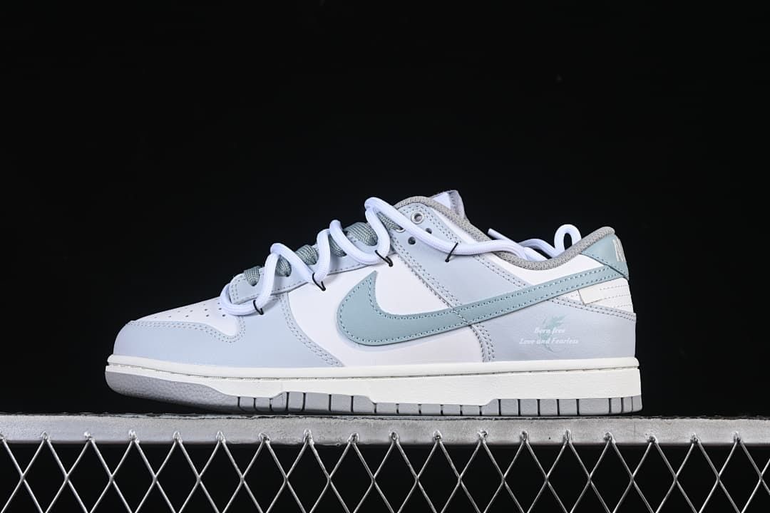 Side view of white and light blue Nike SB Dunk Low sneakers