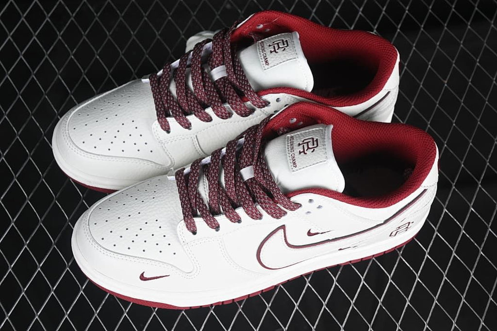 Pair of white and burgundy low-top sneakers viewed from above