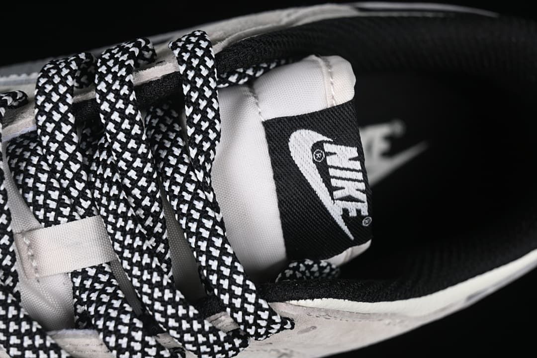 Close-up of the patterned laces, tongue label, and black collar lining