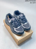 Dark blue and silver ASICS sneakers shown from above on a shoebox