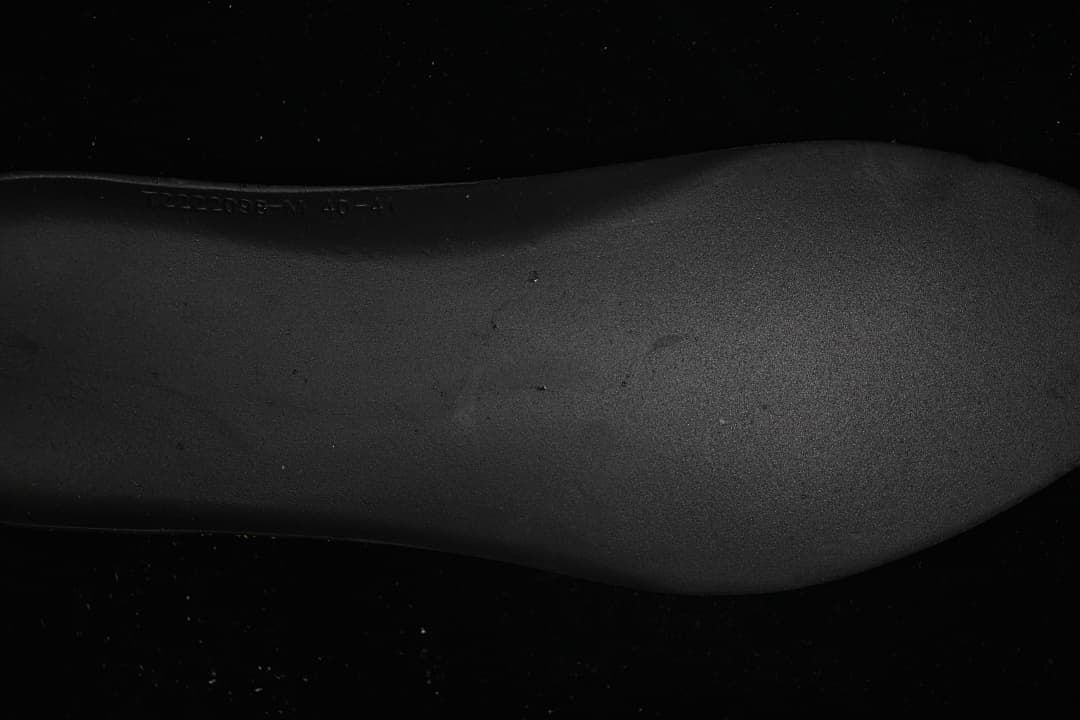 Close-up of the sneaker outsole showing an embossed marking