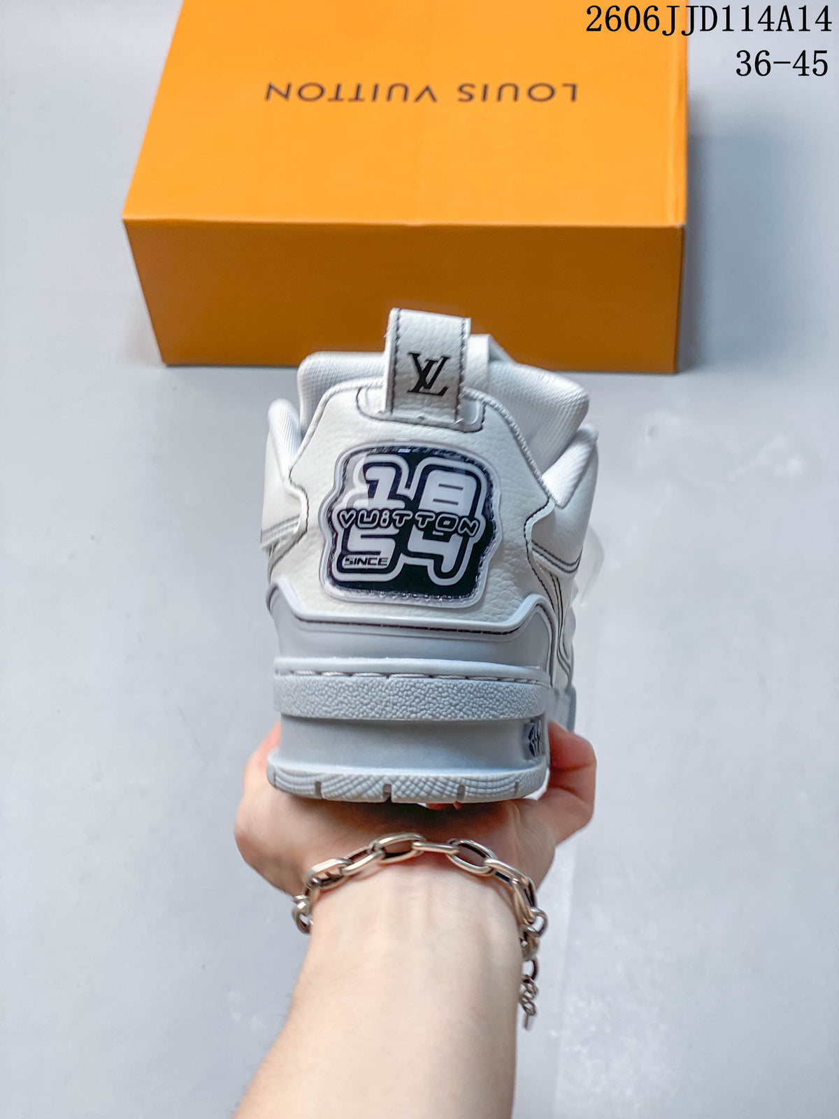 Rear view of a white and gray Trainer sneaker with a logo patch and heel pull tab.