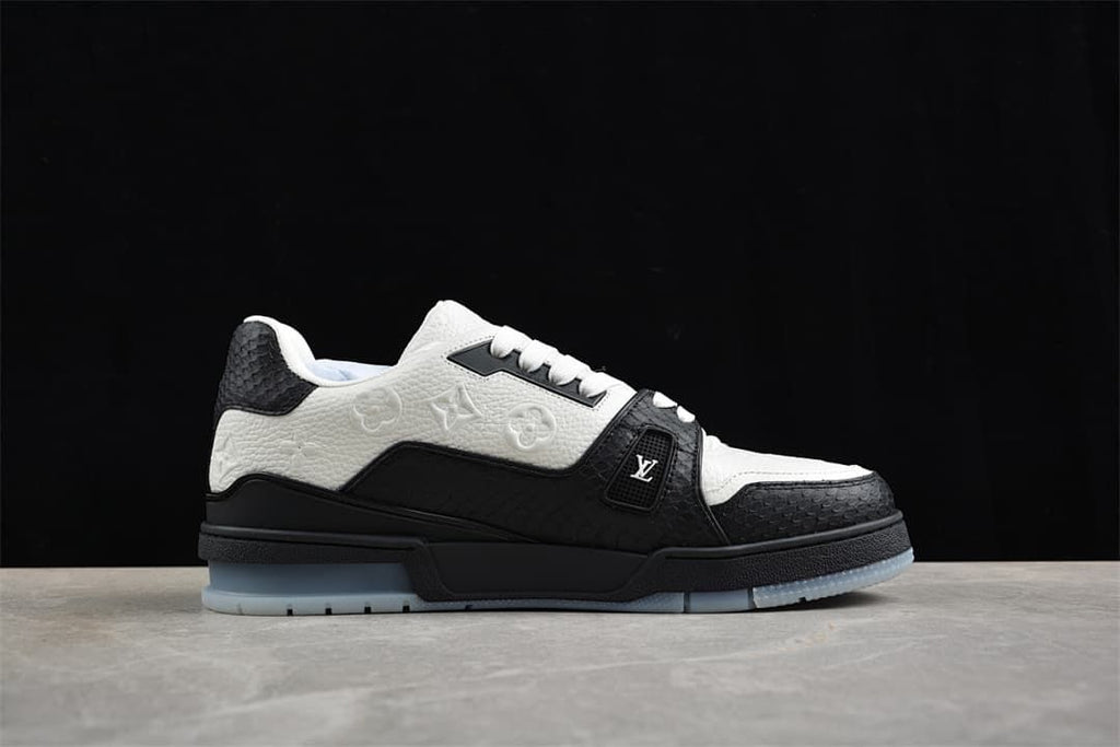 Side profile of the black and white sneaker against a dark backdrop.