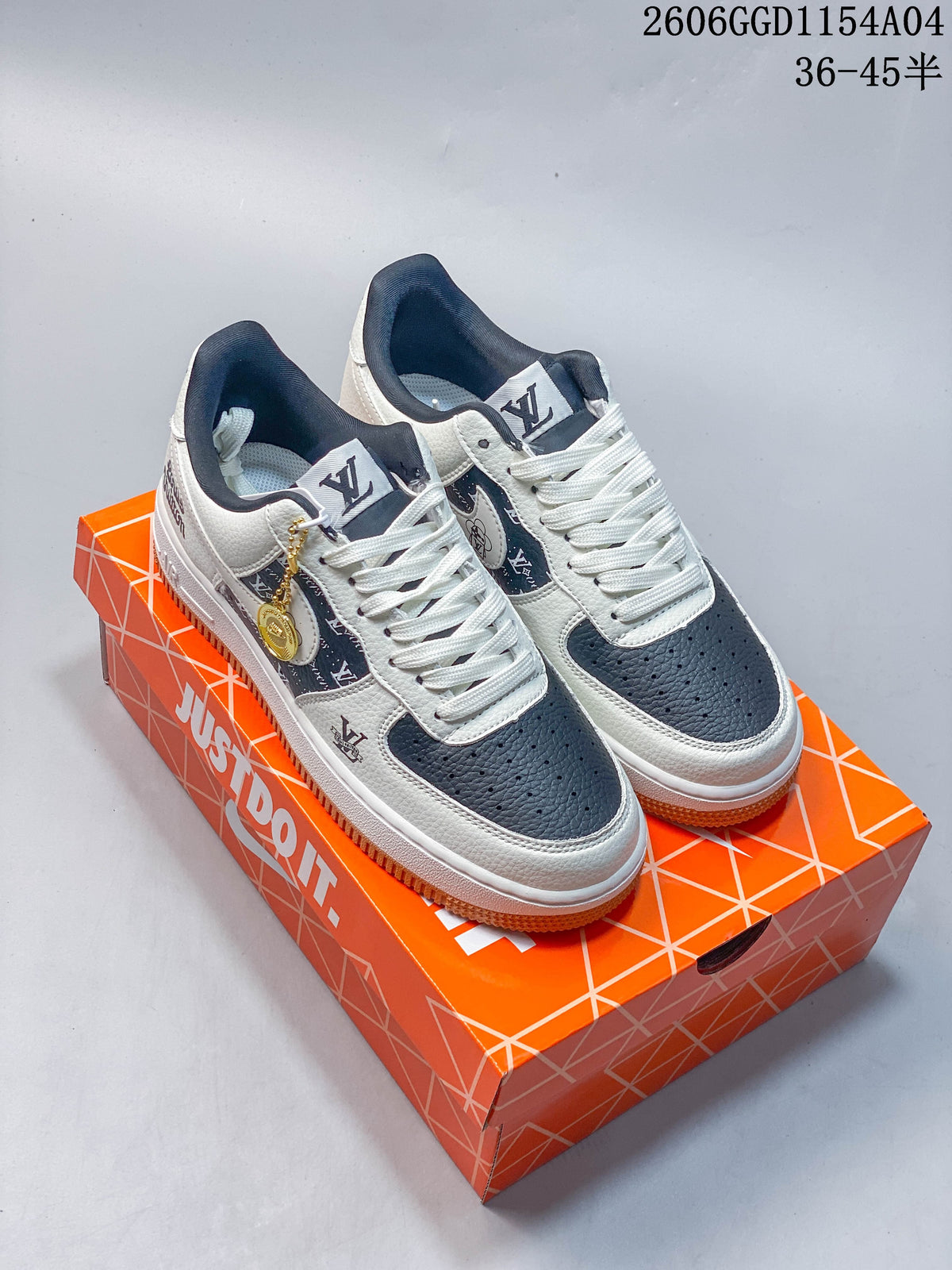 Pair of white and navy low-top sneakers with patterned side panels, gold-tone charms, and gum-colored outsoles.