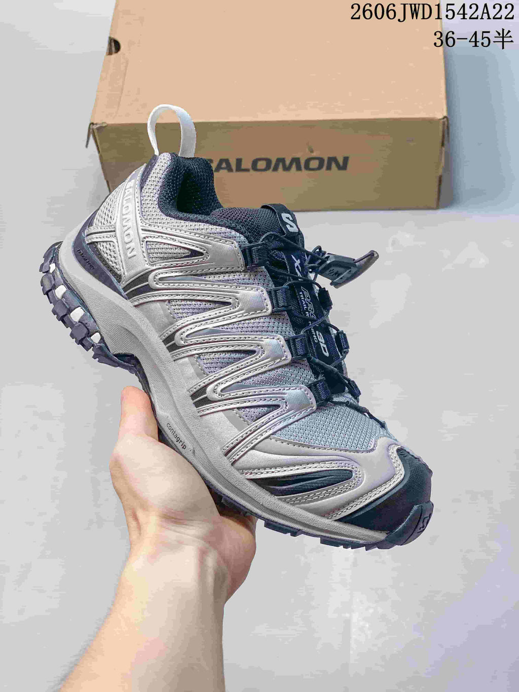 Gray Salomon trail-style sneaker with silver-look overlays and dark laces.