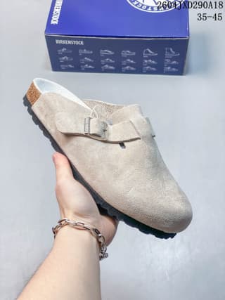 Light gray suede closed-toe clog with a silver buckle, shown with its branded box.
