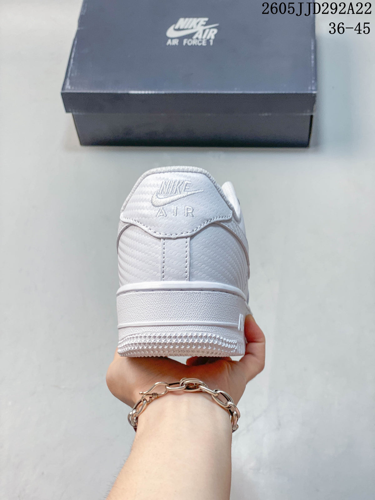 Rear view of a white Nike sneaker with Air branding