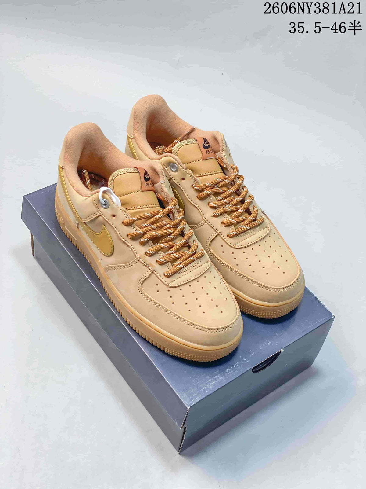 Pair of tan Nike Air Force 1 '07 LV8 low-top sneakers with golden-yellow accents on a shoebox
