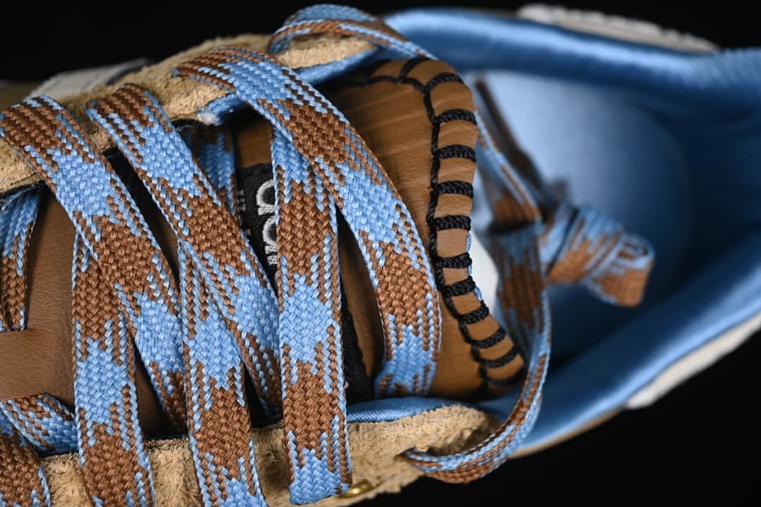 Close-up of patterned blue-and-brown laces and tongue stitching