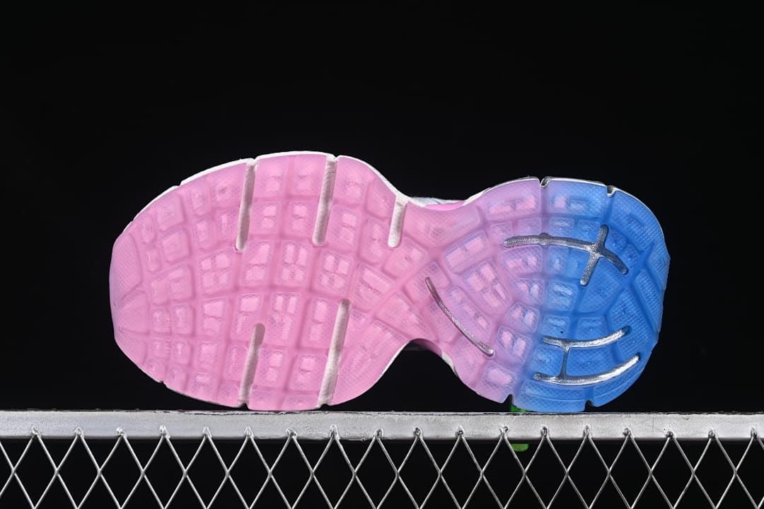 Underside of the sneaker showing a pink-and-blue sole