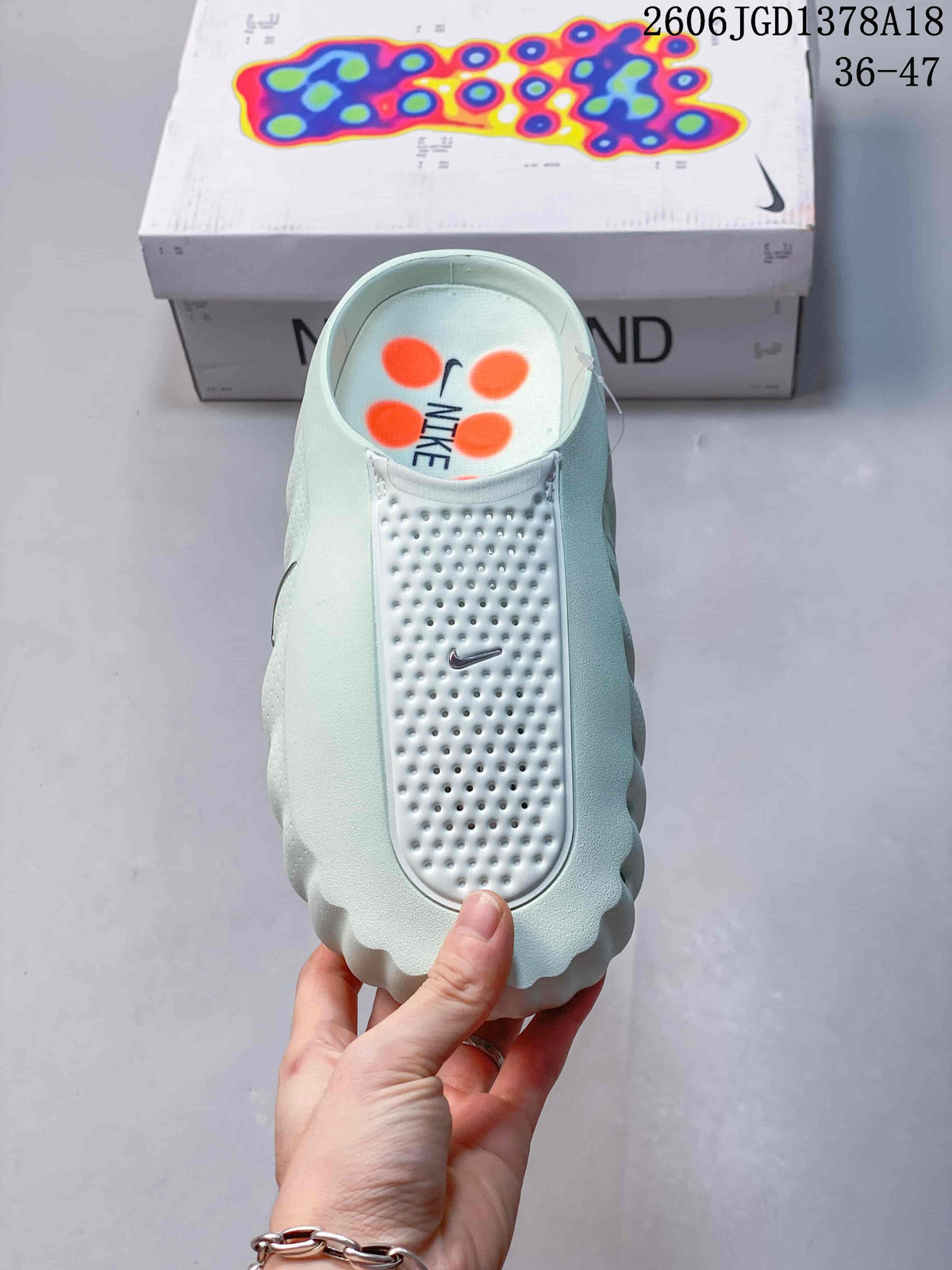 Top view of a pale mint Nike Mind slide with a perforated upper panel
