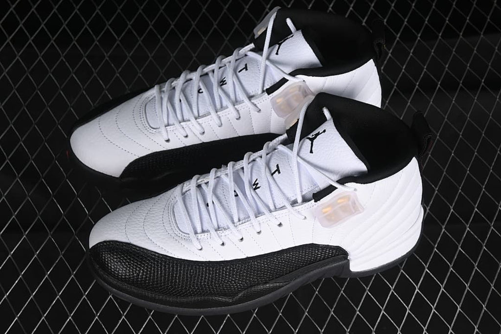 Pair of white and black Air Jordan 12 sneakers viewed from above and the side.