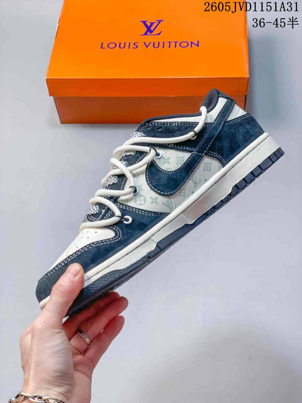Side view of a navy and white low-top sneaker with patterned panels.