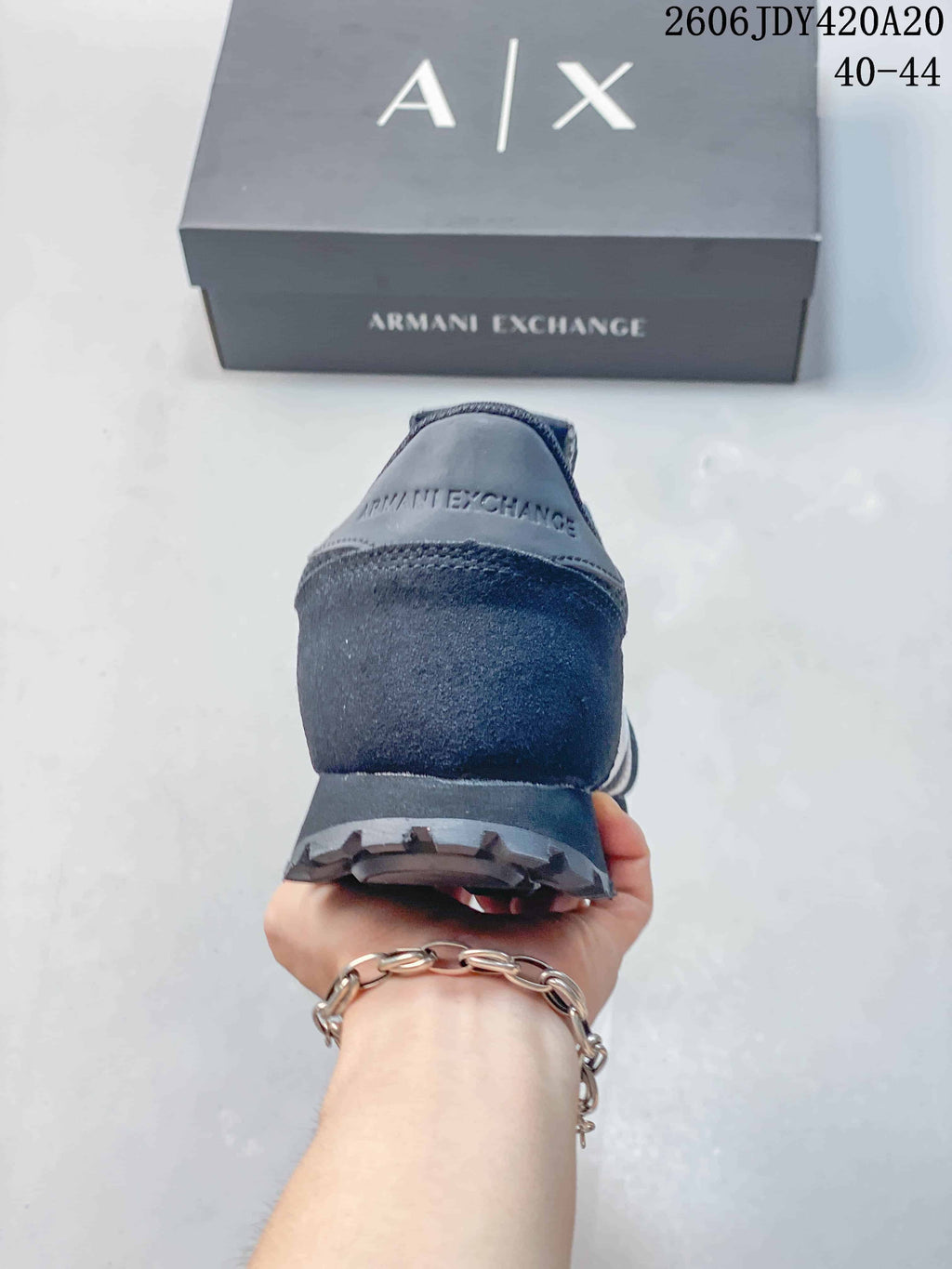 Rear view of a navy sneaker with Armani Exchange branding on the heel