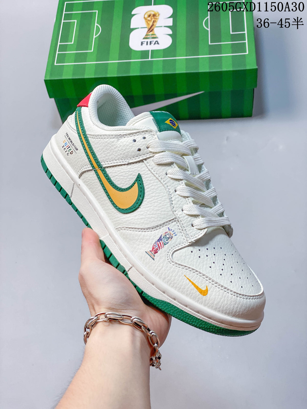 Close view of the sneaker’s side graphics, yellow and green Swoosh, and green outsole.