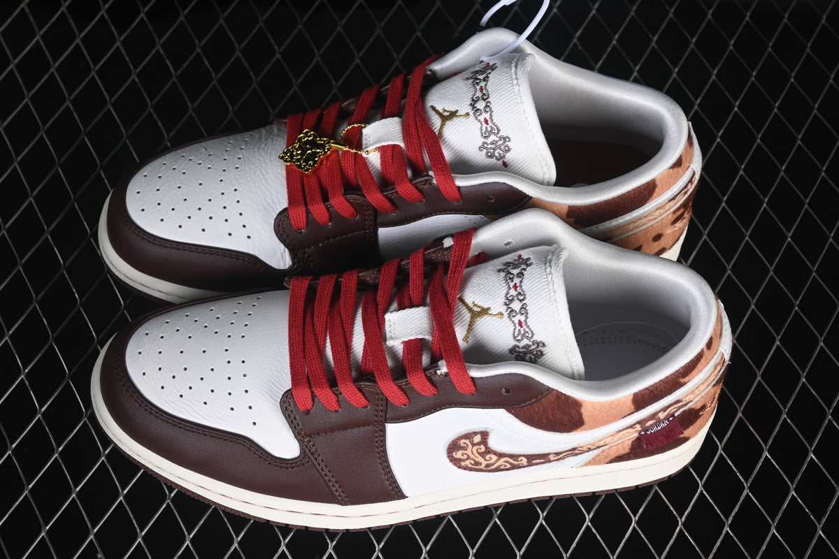 Overhead view of the pair, highlighting red laces, white perforated toe boxes, and patterned brown panels.