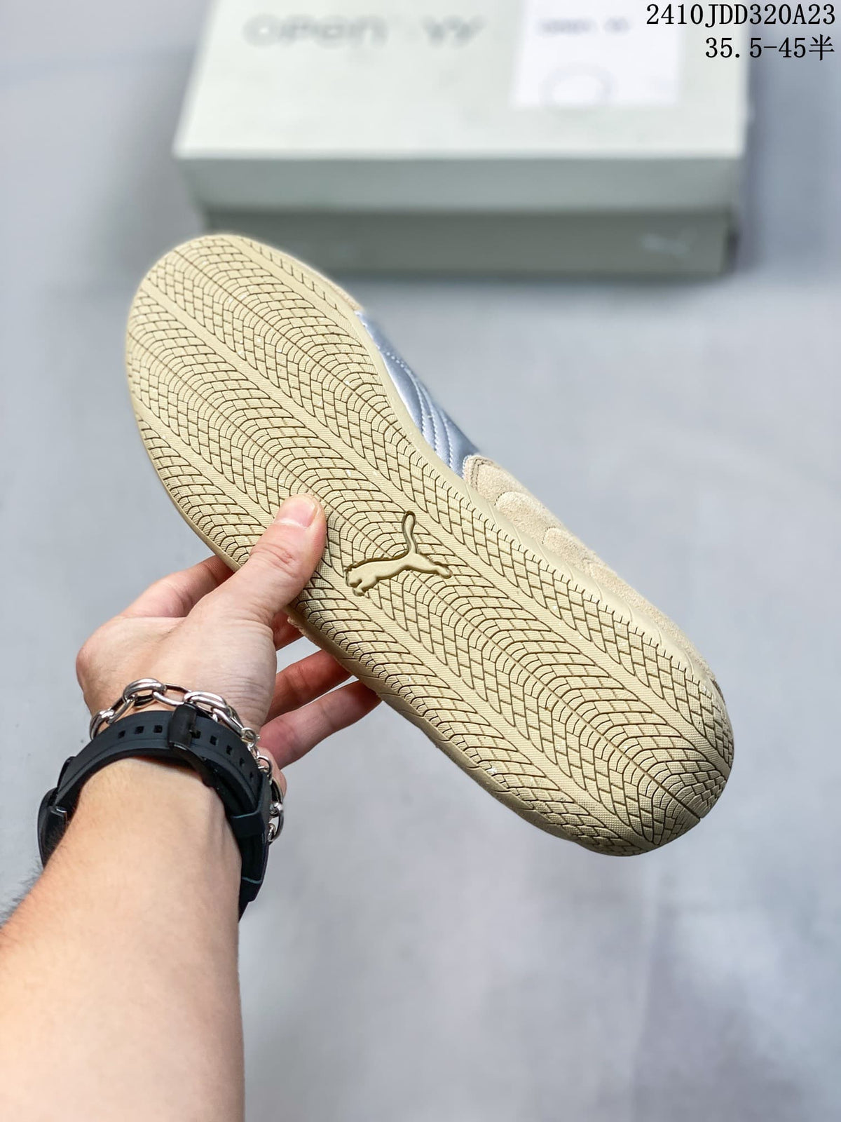 Close-up of the beige patterned outsole on a Puma Speedcat sneaker.