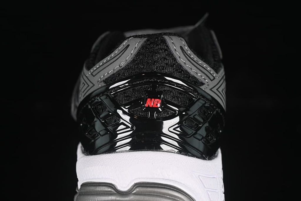 Rear view highlighting the black heel structure, red detail, and white midsole.