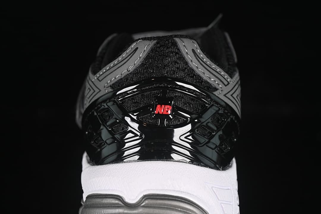 Rear view highlighting the black heel structure, red detail, and white midsole.