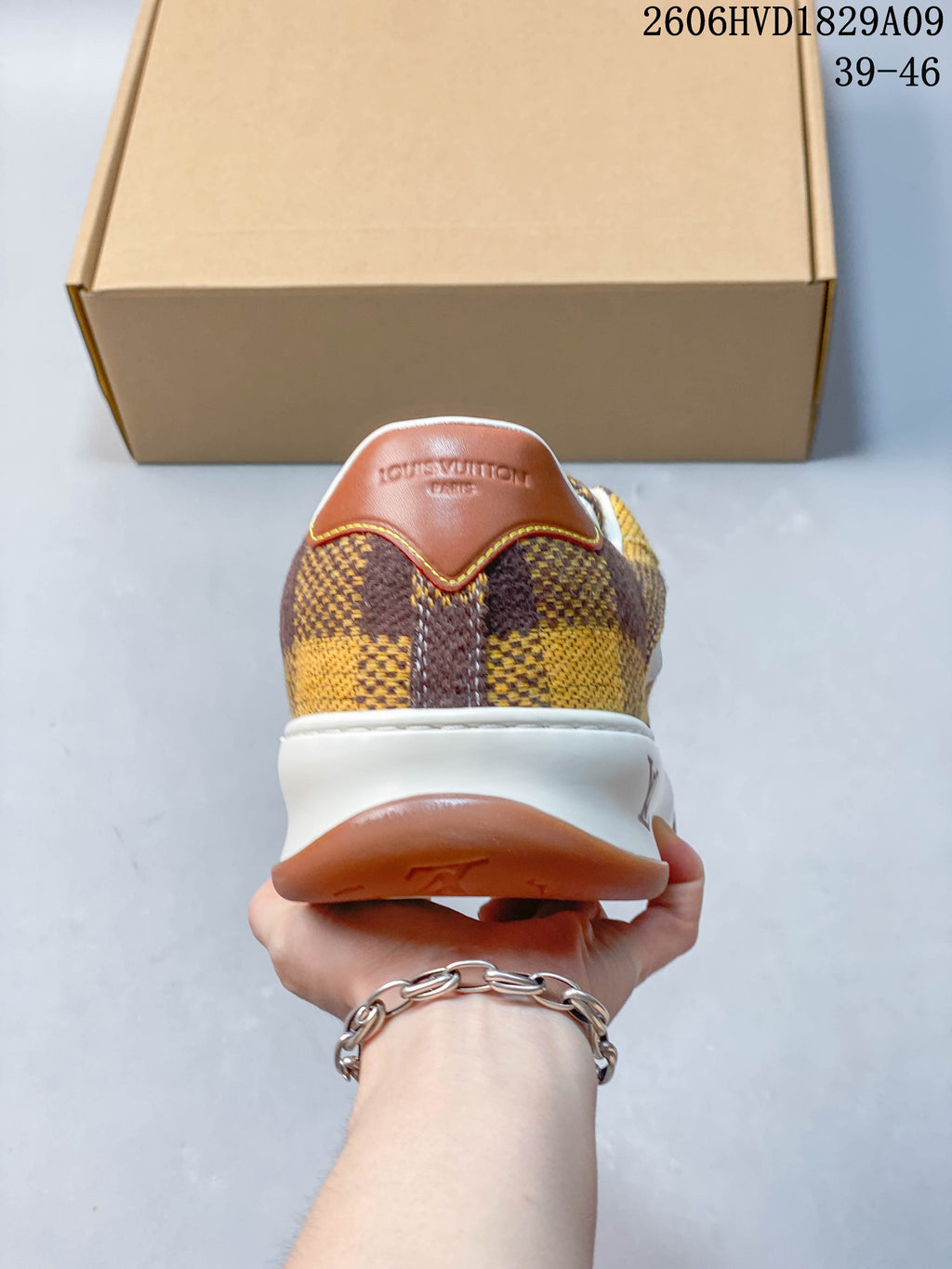 Rear view of checkerboard sneaker with brown heel tab and white midsole