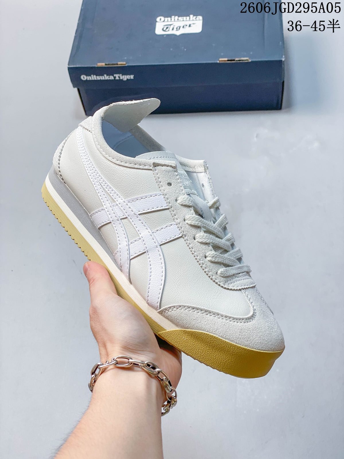 White low-top sneaker with turquoise side stripes and light-colored overlays