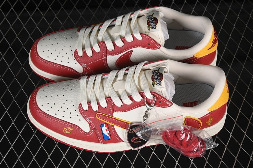 Pair of white and red low-top sneakers with yellow accents, team-themed tags, and extra red laces