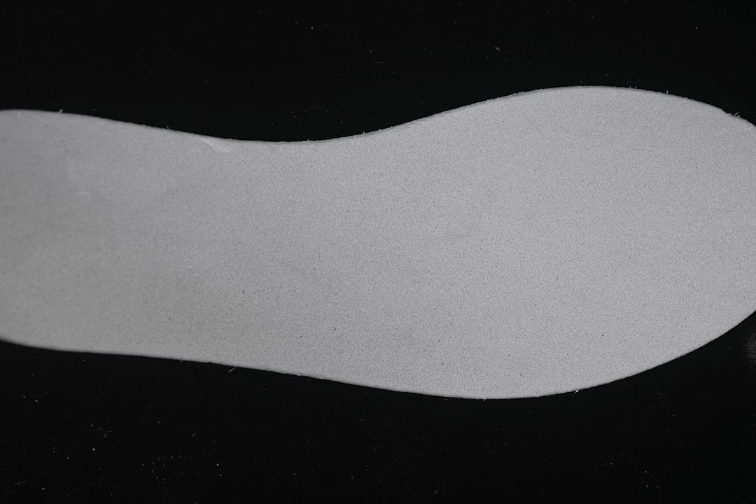 Close-up of a plain light-colored shoe insole.