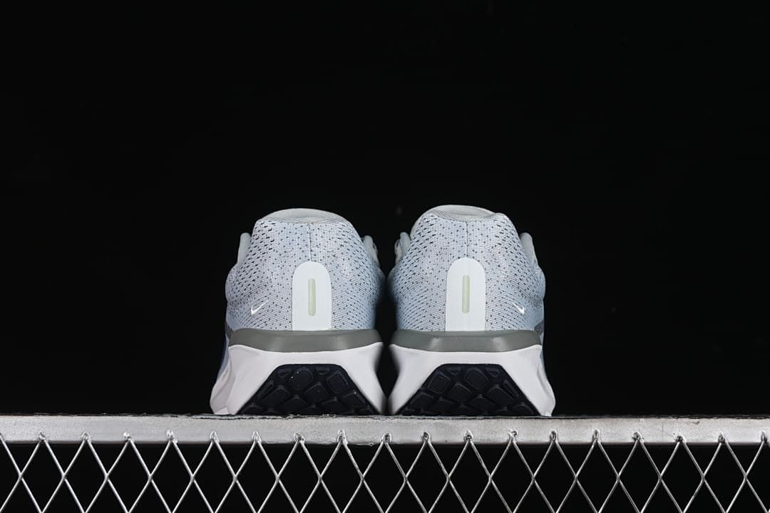 Rear view of both shoes showing the heel counters and outsole edges