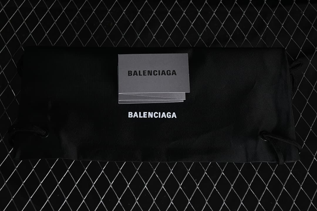 Black Balenciaga-branded shoe bag and printed cards.