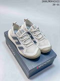 Pair of light grey ECCO mesh-style sneakers with dark side panels displayed on a branded shoe box.