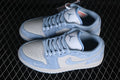 Pair of pale blue and white low-top sneakers viewed from above, showing perforated toe panels, laces, and Jordan tongue logos.