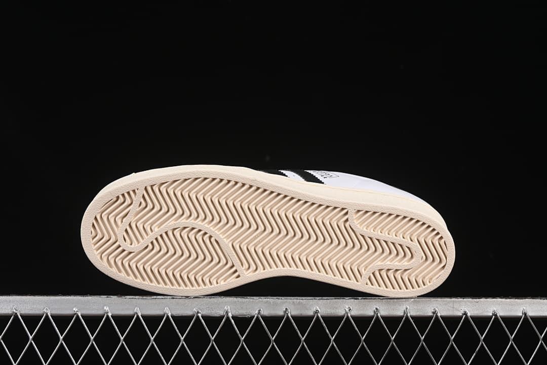 Underside of the sneaker showing the patterned cream outsole