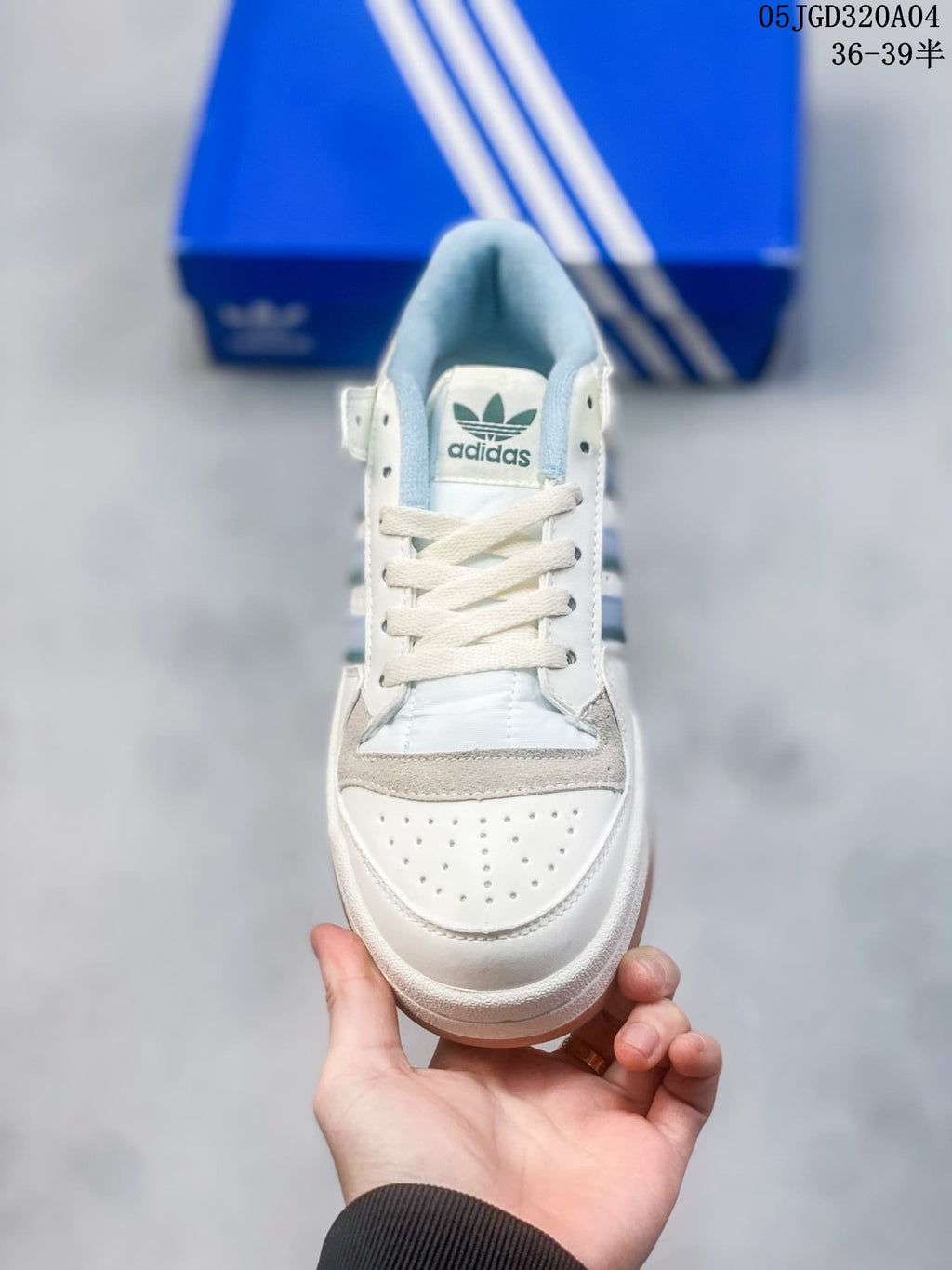 Front view showing the perforated toe, lace-up closure, and light blue lining.