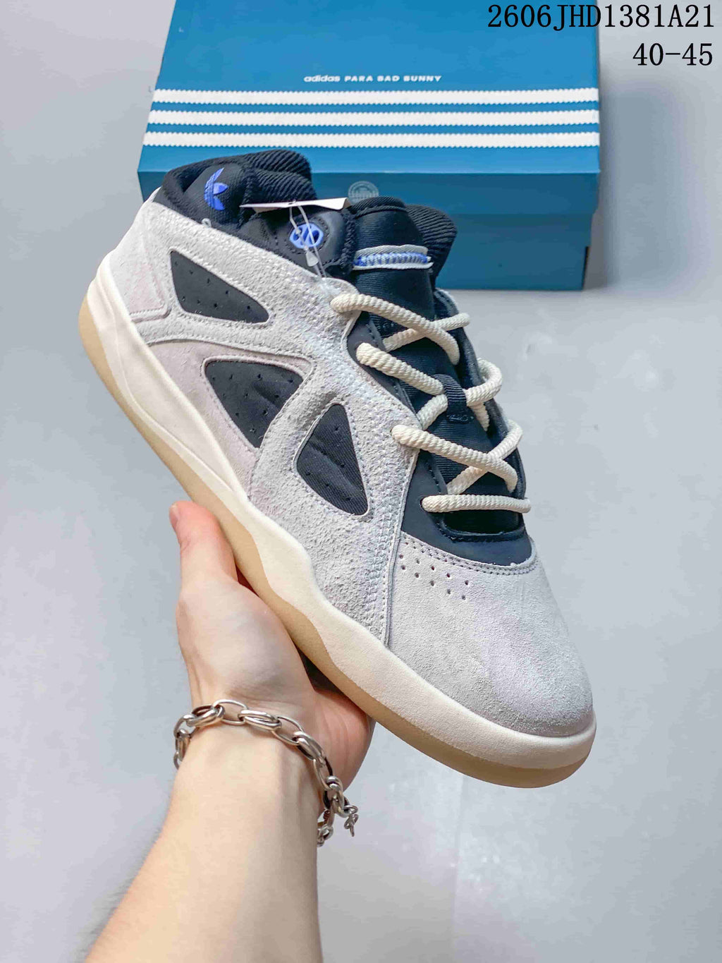 Angled view of the grey and navy sneaker with contrast laces