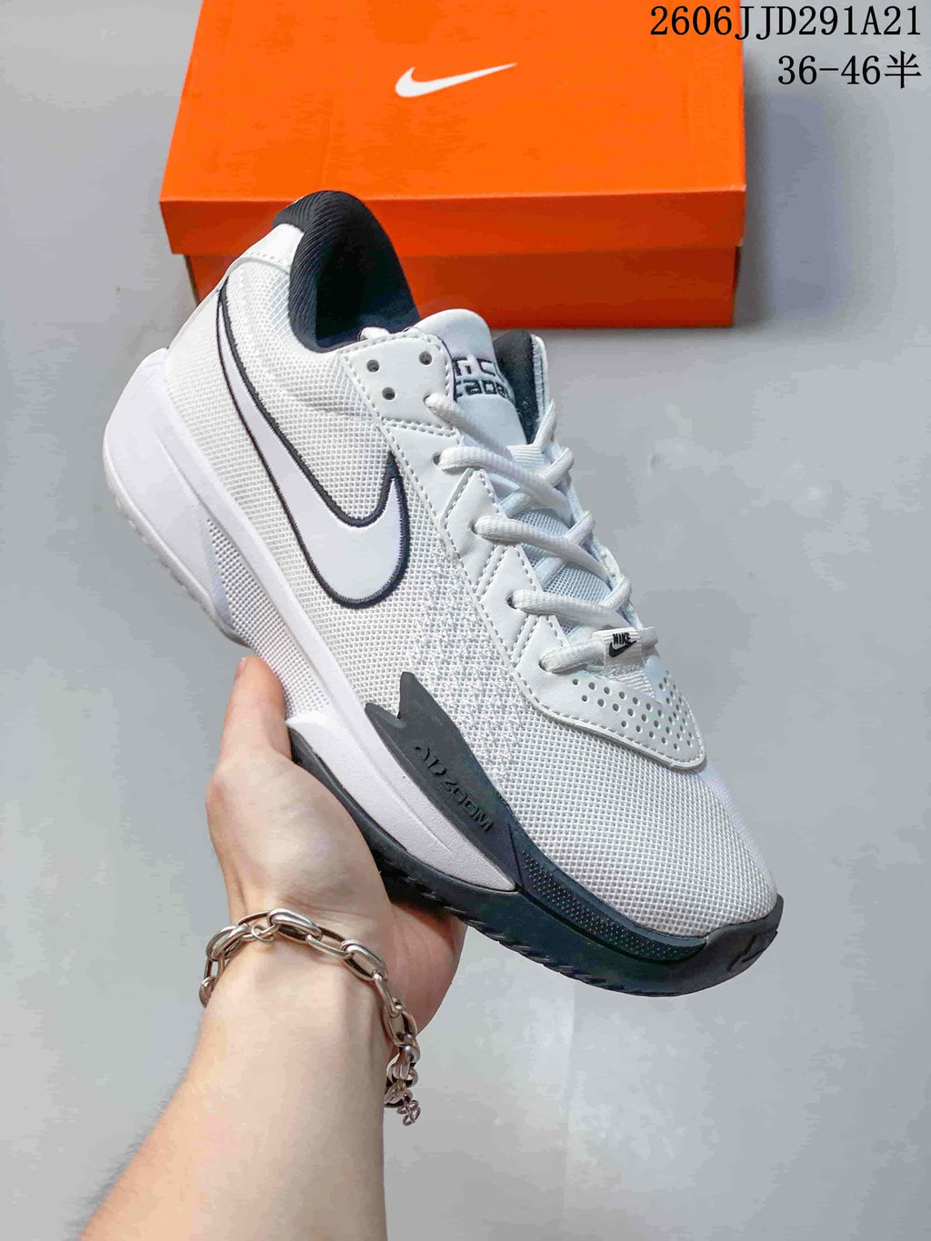 White Nike G.T. Cut 3 basketball shoe with dark Swoosh edging and dark outsole accents.