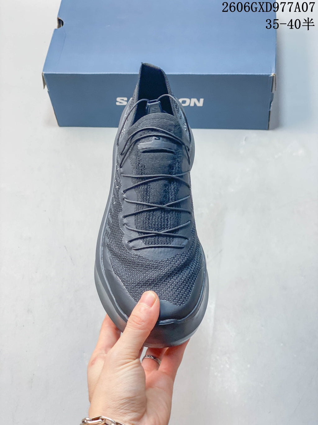 Front view of the gray sneaker showing its upper and lace system.