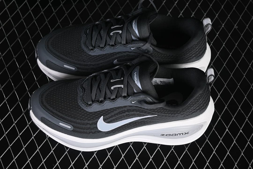Pair of dark Nike Vomero Plus running shoes shown from above at an angle.